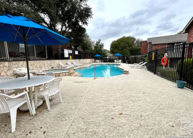 a view of a house with swimming pool and sitting area