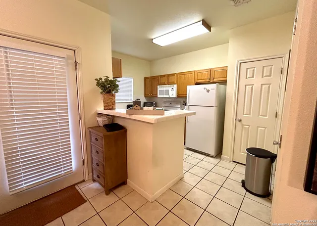 a kitchen with refrigerator and stove
