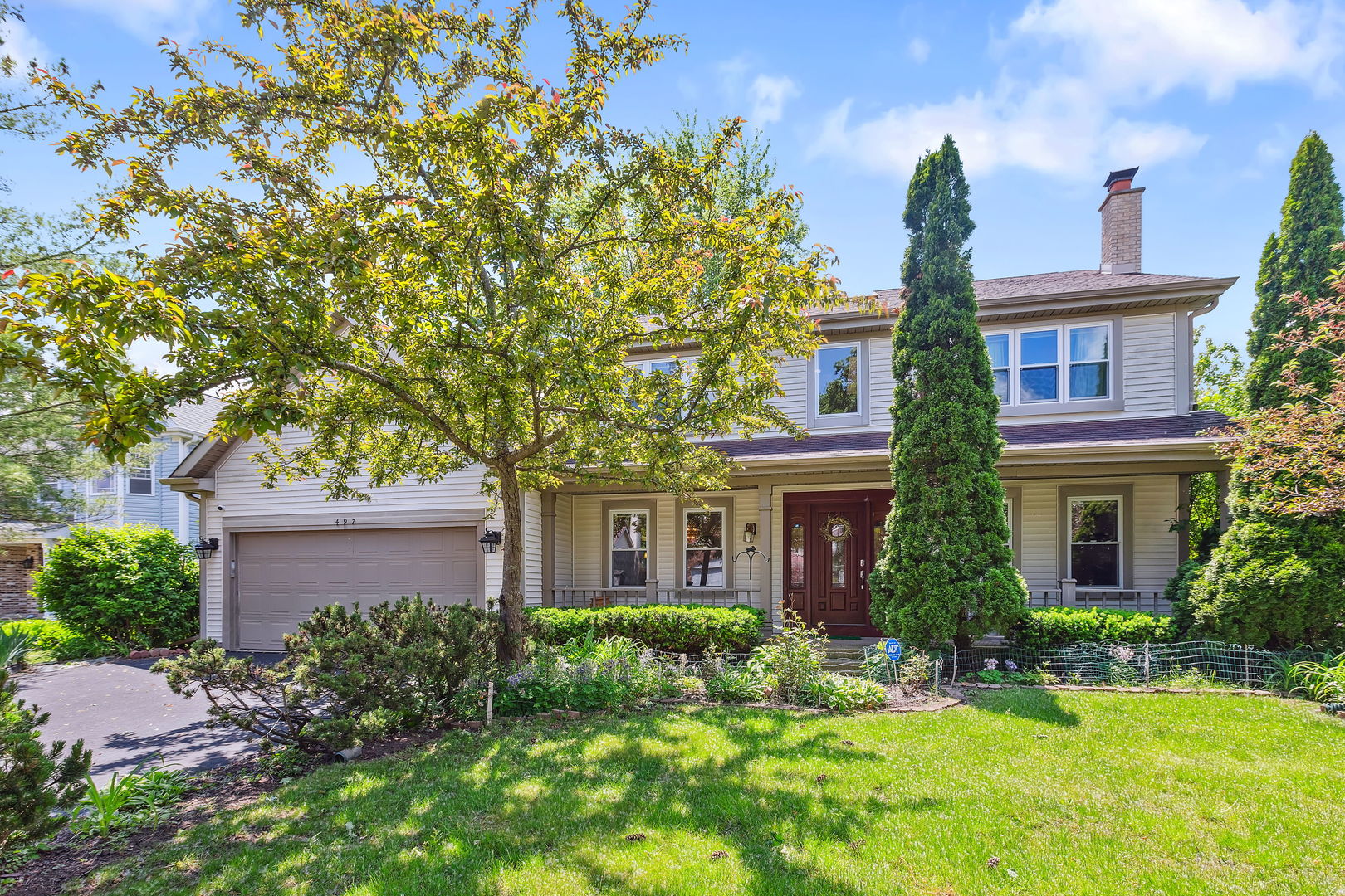 497 Farm Bridge Road Lake Zurich, IL 60047 - Photo 1 of 27 a front view of a house with a yard and trees