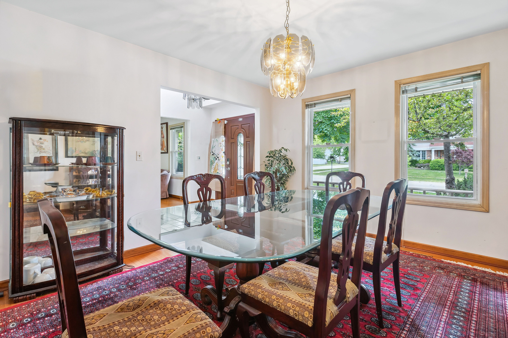 497 Farm Bridge Road Lake Zurich, IL 60047 - Photo 5 of 27 a view of a dining room with furniture wooden floor and chandelier