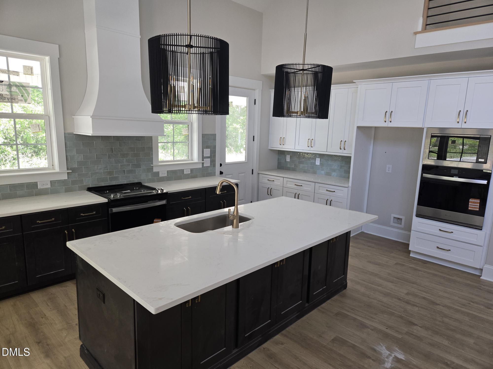 300 Avery Road Erwin, NC 28339 - Photo 3 of 38 a kitchen with stainless steel appliances a stove a sink a microwave a refrigerator a sink a stove and white cabinets