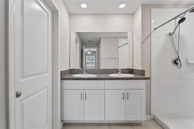 a bathroom with a granite countertop toilet a sink and a mirror