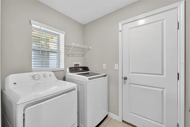 a utility room with washing machine