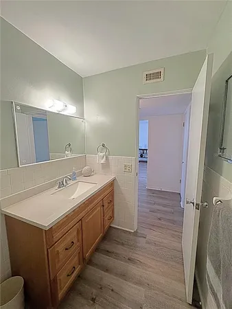 a spacious bathroom with a double vanity sink and a mirror