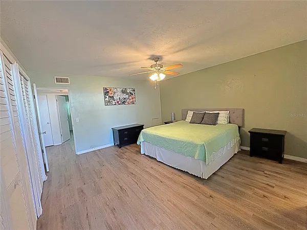 a bedroom with a bed and a chandelier