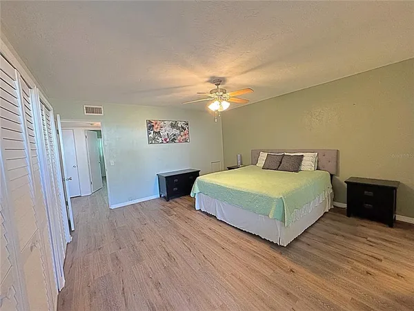 a bedroom with a bed and a chandelier