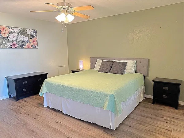 a bedroom with a bed and a night stand