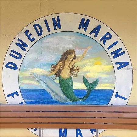 a utility room with stainless steel appliances granite countertop a sink dishwasher and a stove with wooden floor