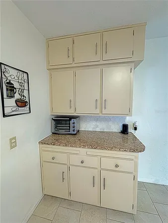a kitchen with granite countertop cabinets sink and cabinets