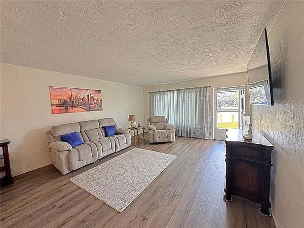 a spacious bedroom with a bed and a couch