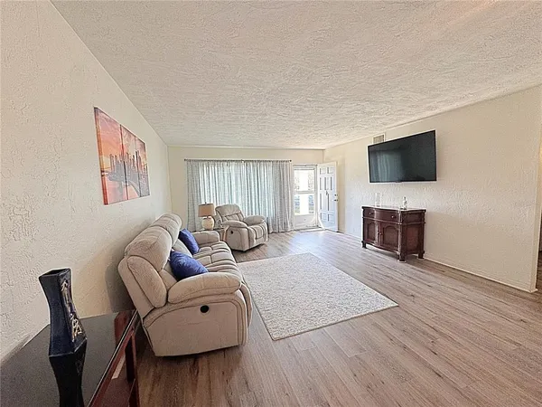 a living room with fireplace furniture and a flat screen tv
