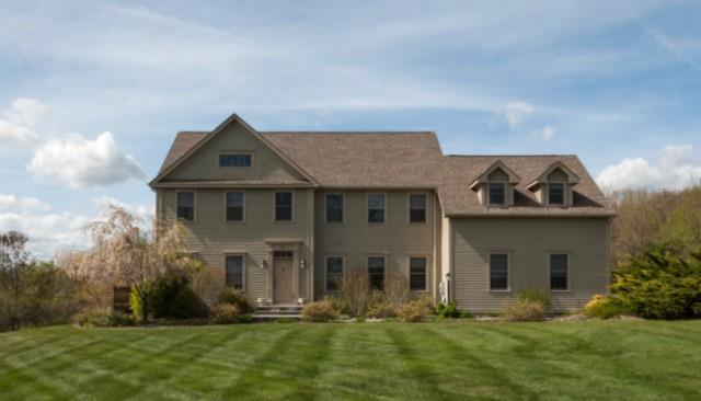 28 Grassy Hill Road Roxbury, CT 06783 - Photo 1 of 1 a front view of a house with a yard and garage