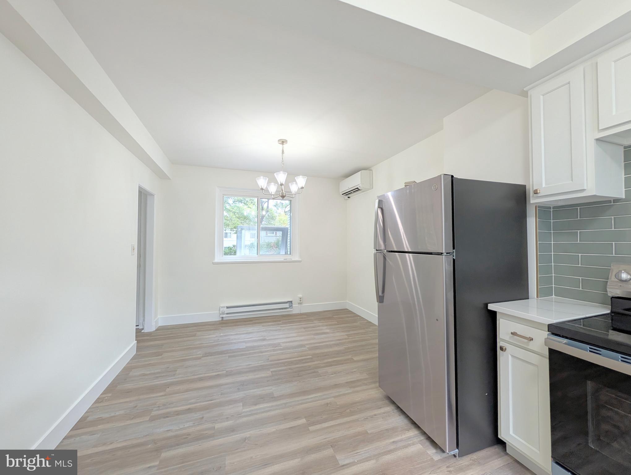 21 Ridge Road Greenbelt, MD 20770 - Photo 5 of 13 a view of a refrigerator in kitchen and an empty room