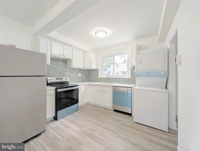 a kitchen with a refrigerator stove and sink