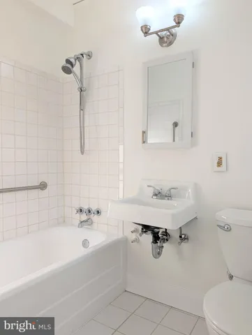 a bathroom with a sink a toilet and bathtub