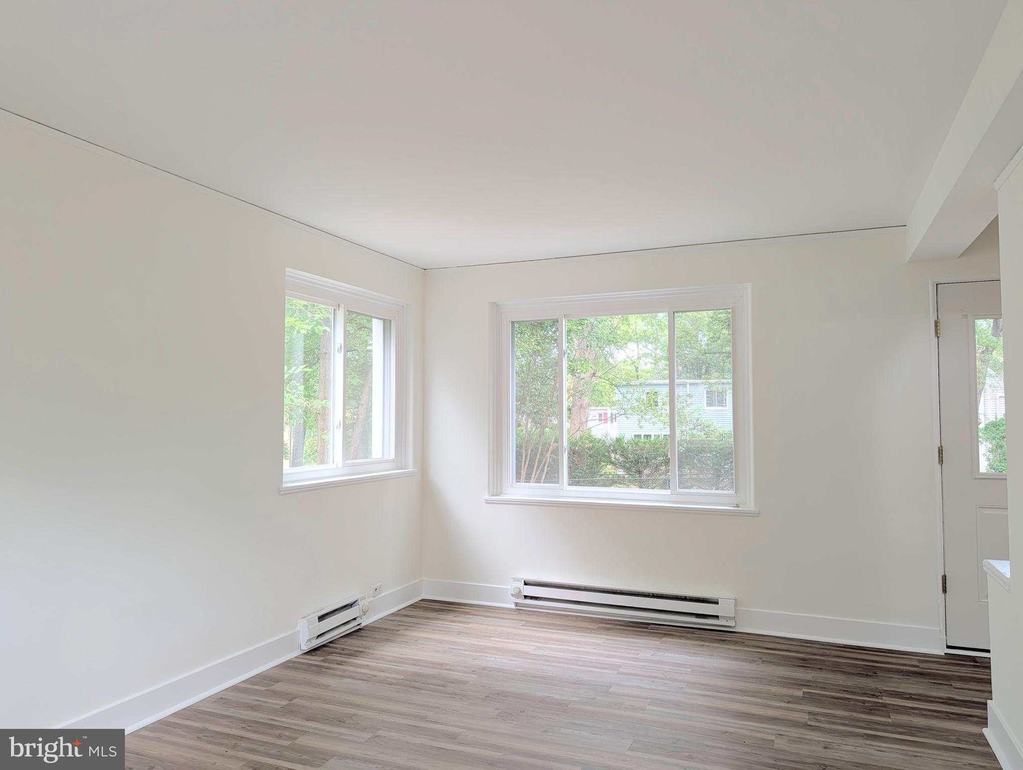 21 Ridge Road Greenbelt, MD 20770 - Photo 8 of 13 a view of an empty room with wooden floor and a window