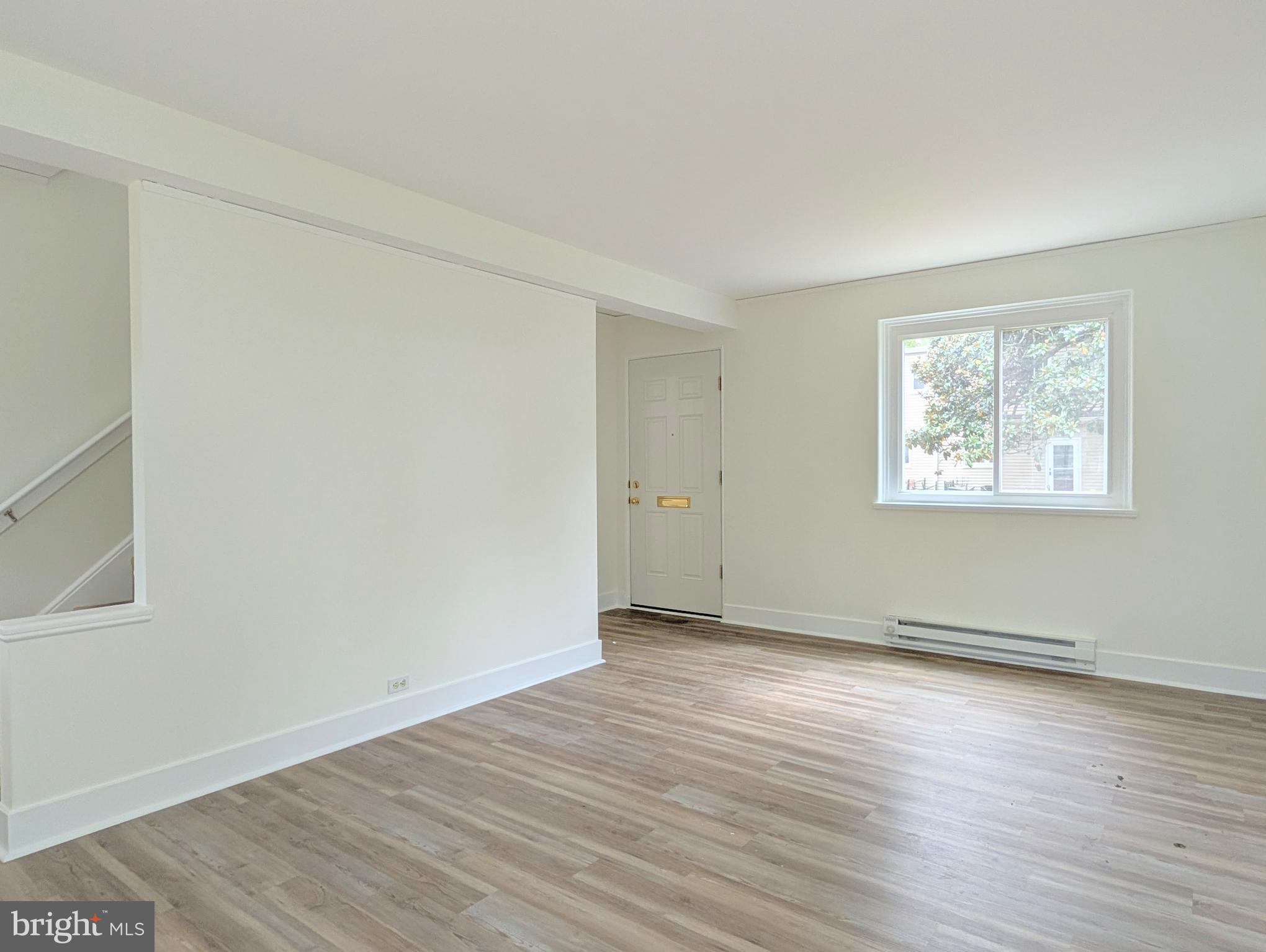 21 Ridge Road Greenbelt, MD 20770 - Photo 9 of 13 an empty room with wooden floor and windows