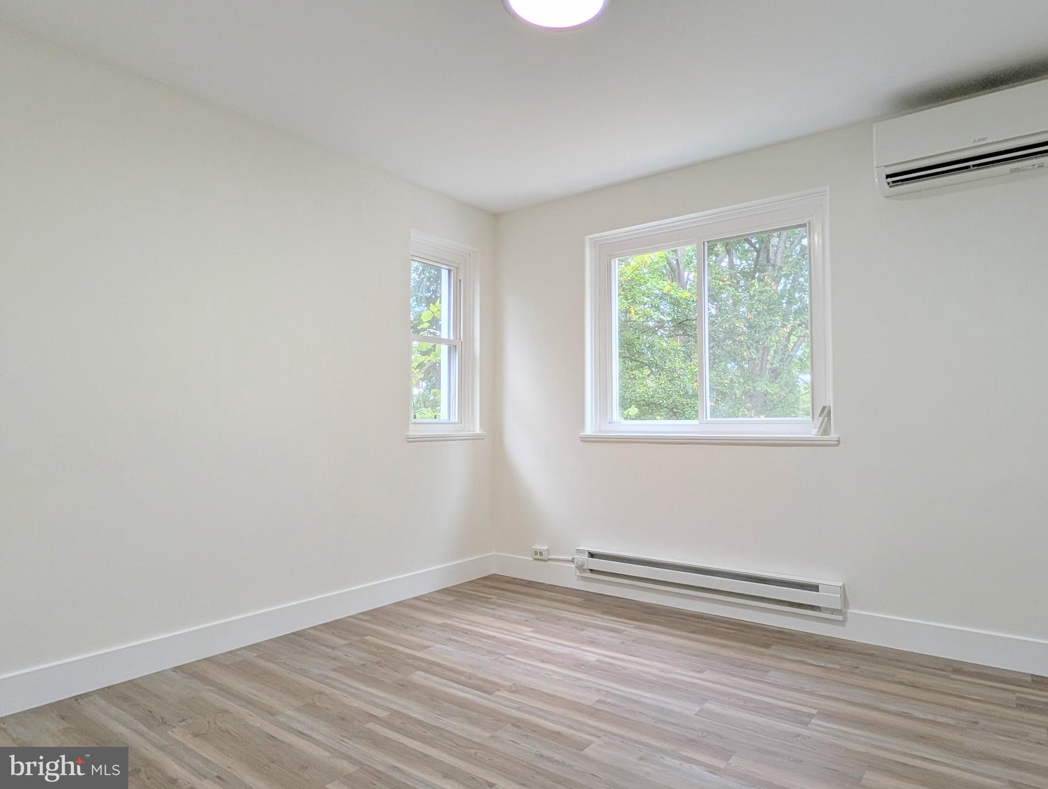 21 Ridge Road Greenbelt, MD 20770 - Photo 10 of 13 an empty room with wooden floor and windows