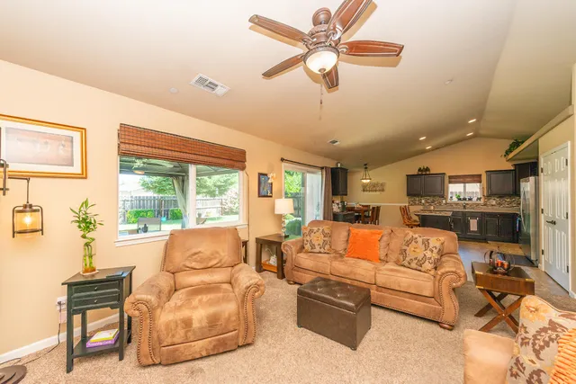 a living room with furniture large window and fireplace