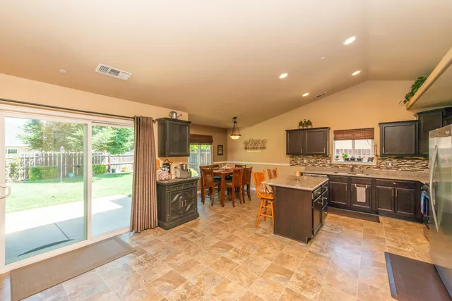 a kitchen with a refrigerator and a stove top oven