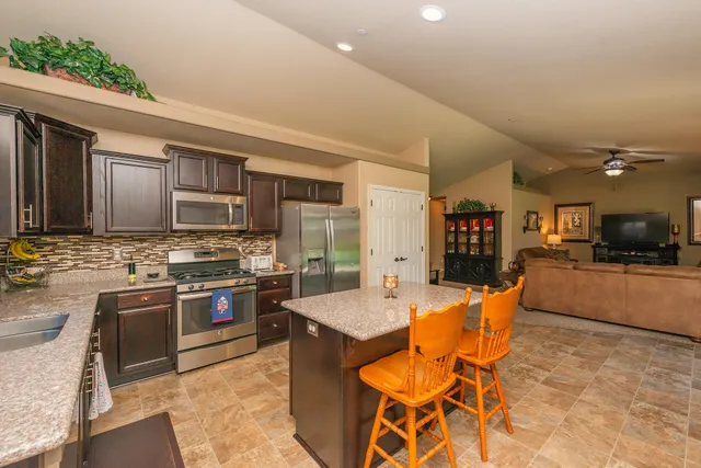 a dining room with furniture a chandelier and wooden floor