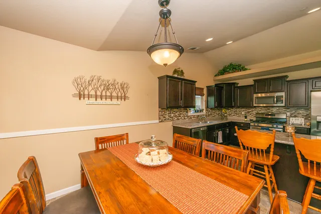 a bathroom with a granite countertop toilet sink and mirror