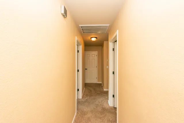 a bed room with a bed and a ceiling fan