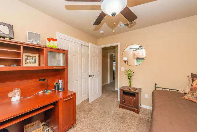 a bathroom with a granite countertop sink a mirror a vanity and shower
