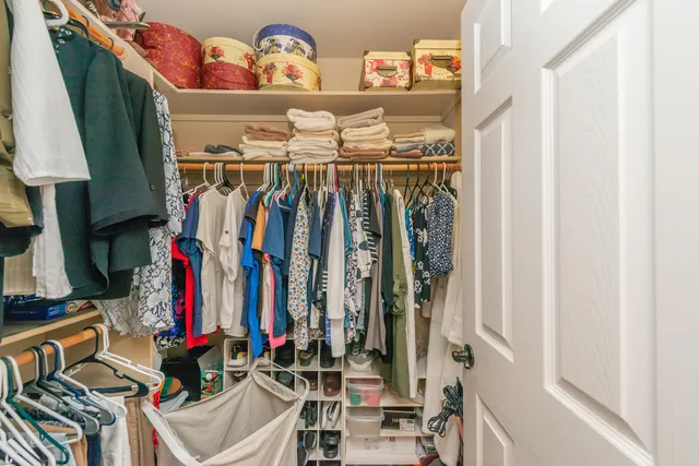 a view of backyard with a table and chairs and a large tree