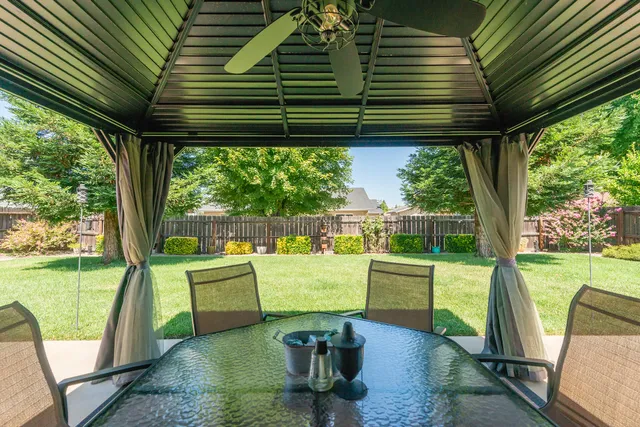 a front view of a house with a garden and yard