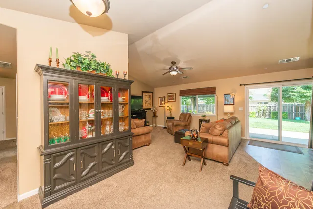 a living room with furniture a flat screen tv and a large window