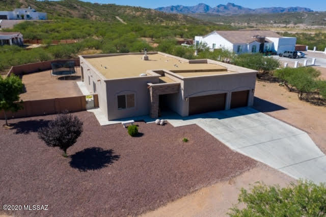 407 Camino Agua Fria Rio Rico, AZ 85648 - Photo 37 of 41 an aerial view of a house with a yard and a large tree