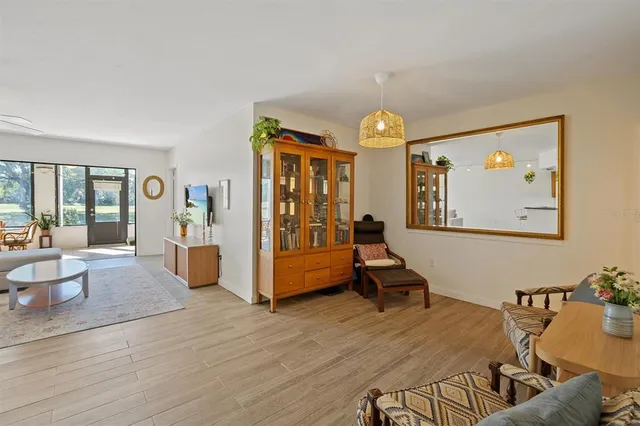 a living room with furniture and a chandelier