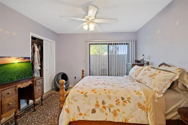 a bed sitting in a spacious bedroom next to a window