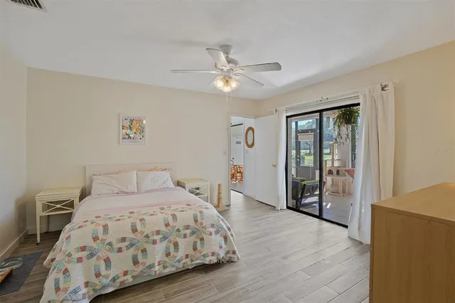 a bedroom with a large bed and a chandelier
