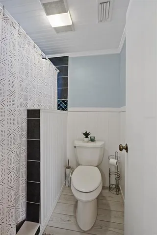 a bathroom with a toilet and a shower