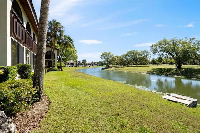 a view of a lake with houses in the back
