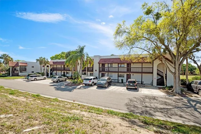 a row of palm trees in front of a house