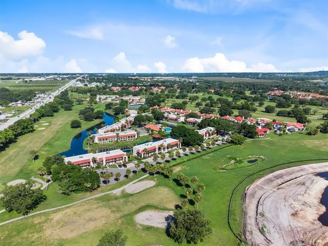 an aerial view of a houses with a swimming pool