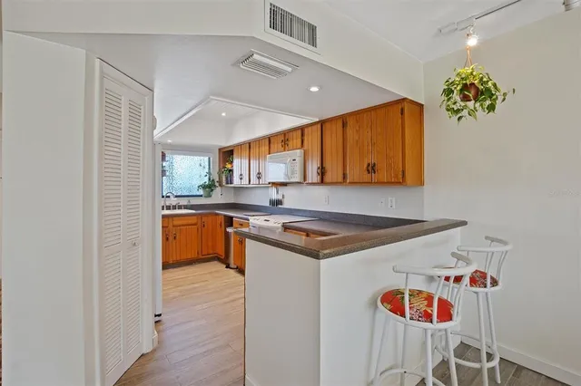a kitchen with a sink a stove and cabinets