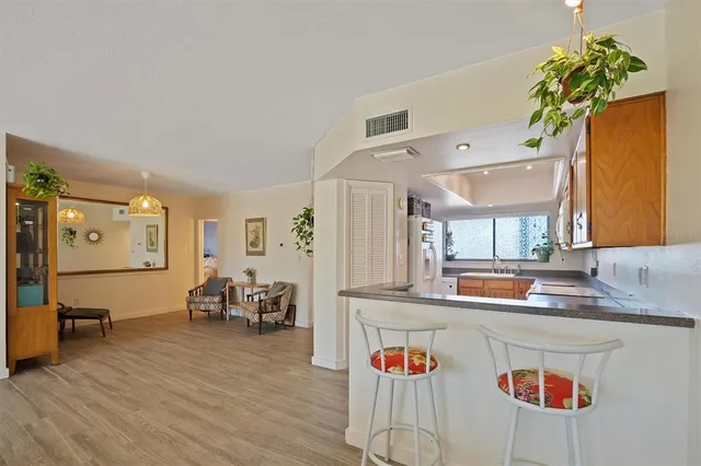 a living room with a couch and a potted plant