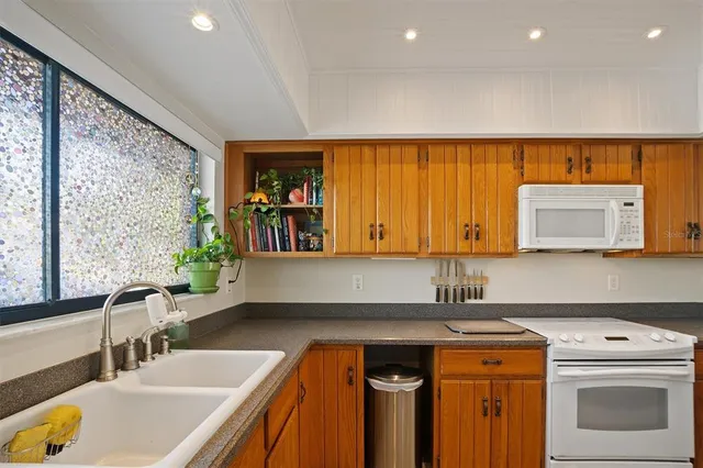 a kitchen with a sink a stove and a refrigerator