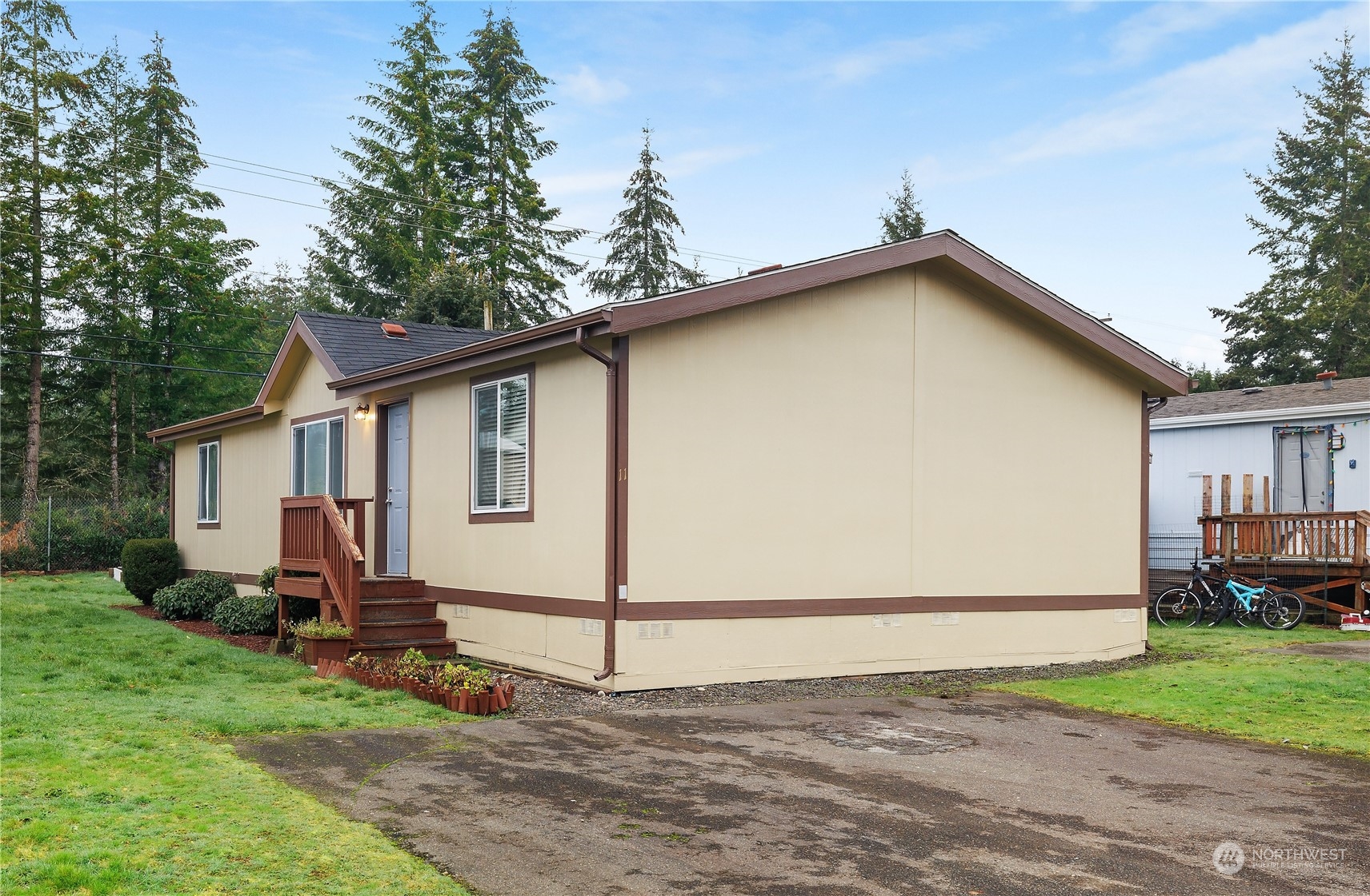 10324 Delphi Road Southwest, Unit 11 Olympia, WA 98512 - Photo 1 of 20 a backyard of a house with wooden fence and trees