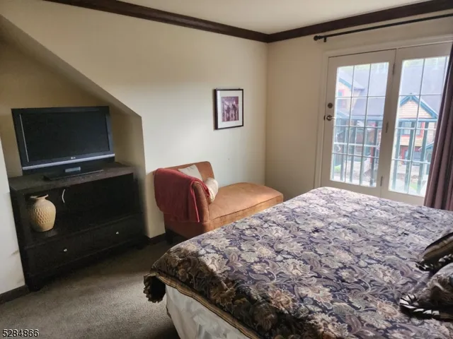 a bedroom with bed and a window