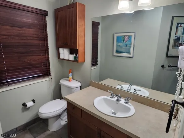 a bathroom with a toilet sink and mirror