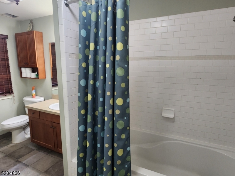 1 Pine Crescent, Unit 23 Vernon, NJ 07462 - Photo 25 of 28 a bathroom with a granite countertop sink a toilet and shower