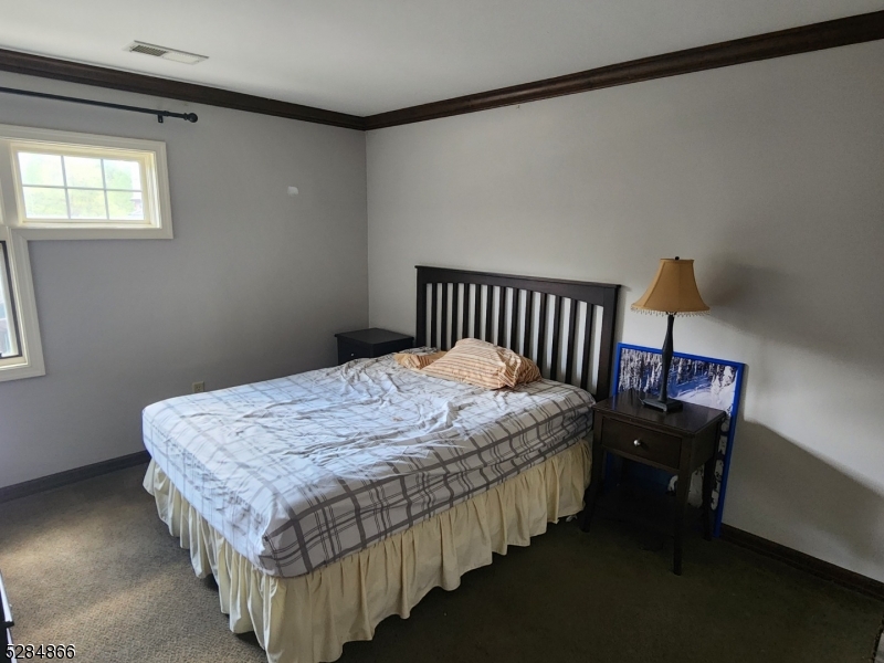 1 Pine Crescent, Unit 23 Vernon, NJ 07462 - Photo 28 of 28 a bedroom with bed wooden floor and window