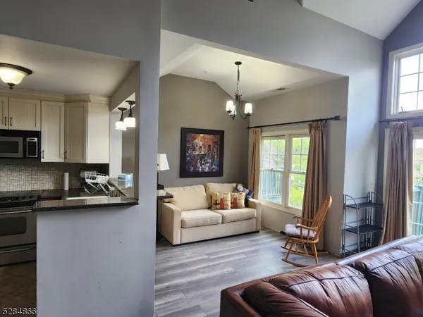 a living room with furniture and a chandelier