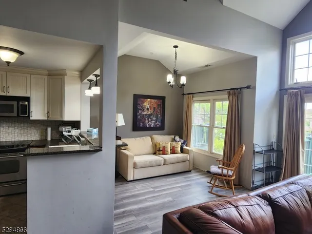a living room with furniture and a chandelier