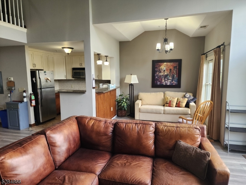 1 Pine Crescent, Unit 23 Vernon, NJ 07462 - Photo 5 of 28 a living room with furniture kitchen and a chandelier